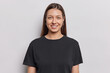 © WHstudio Leushin N - Portrait of good looking young woman with no makeup natural beauty has long dark straight hair dressed in casual black t shirt poses against white background poses in studio for making photo