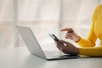 A person holds a mobile phone to use social media on a smartphone, communicating via the Internet on a smartphone. The concept of using technology in communication.
