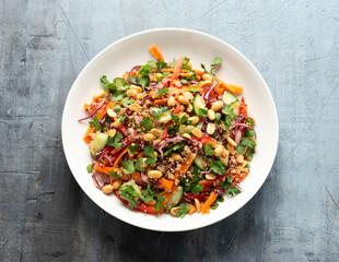 Wall Mural - Asian Quinoa salad with fresh vegetables, peanuts and herbs. Healthy food.