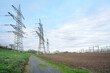 Power lines and substation, extra high voltage lines behind the electrical grid. High-voltage power line, transmission tower overhead line masts, high voltage pylons, power pylons on the fields