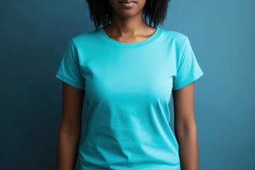 Wall Mural - Black woman model wearing a plain cyan short sleeved t-shirt, isolated on a blank background. Mock-up, torso only. Generative AI illustration.