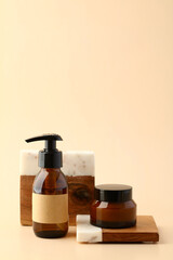 Wall Mural - set of amber glass cosmetic bottle and jar of moisturizer on podium. natural spa beauty products des
