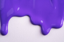 Violet Liquid Drops Of Paint Color Flow Down On White Canvas. Abstract Art. Lilac Paint Dripping On The White Wall