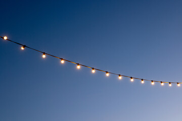 light bulbs garlands against sky