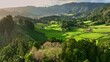 Aerial shot of green meadows, mountains and Furnas city on Sao Miguel Island, Azores, Portugal . Azores nature on sunny day