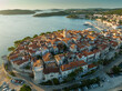 Aerial sunrise view of Korcula old town on Korcula island, Croatia. Magnificent islands in the Adriatic Sea, travel destination. Flying over medieval mediterranean Croatian town of Korcula