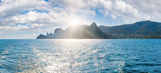 Canvas Print - Scintillate sea surface and evening sunshiny summer rocky coastline, Crimea, Ukraine.