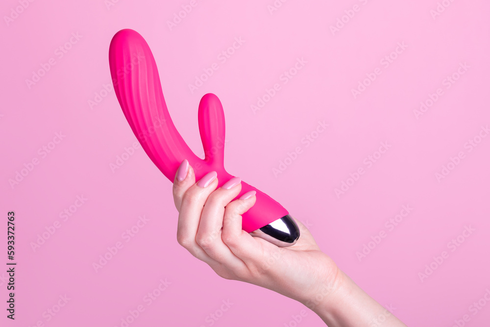 Pink sex toy rabbit shaped vibrator for women in female hand isolated on light pink background Stock Photo | Adobe Stock Pink sex toy rabbit shaped vibrator for women in female hand isolated on light pink background Stock Photo | Adobe Stock