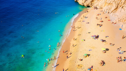 Canvas Print - Aerial view on beach and umbrellas. Sumer vacation and adventure. Beach and blue water. Top view from drone at beach and azure sea.