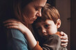© VisualProduction - Sad little child, boy, hugging his mother at home. Mother protecting and caring for her crying child in danger. Generative AI.