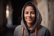 Group portrait photography of a grinning woman in her 30s wearing a stylish hoodie against an ancient egyptian or hieroglyphics background. Generative AI