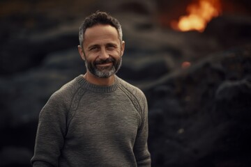 Wall Mural - Medium shot portrait photography of a pleased man in his 40s wearing a cozy sweater against a volcano or lava background. Generative AI