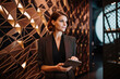 © aicandy - Portrait of a beautiful event planner in a stylish outfit, holding a tablet and standing in front of a modern event space with geometric decor, generative ai