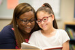 © aicandy - Portrait of a special education teacher reading a book with a student, both smiling and engaged, generative ai