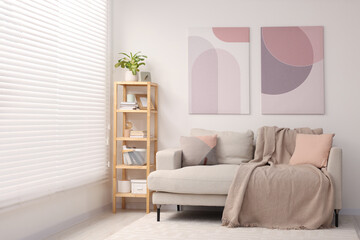 Sticker - Stylish living room interior with cozy sofa and wooden shelf