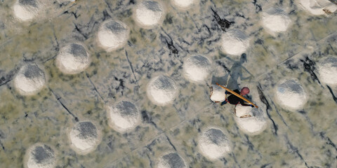 Wall Mural -  Aerial view of worker harvesting salt in salt field at Ban Laem-Thailand	