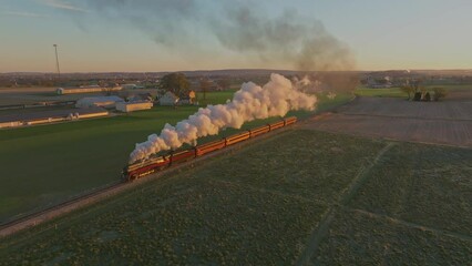 Canvas Print - Drone View of a Steam Engine Approaching Blowing Lots of Smoke in the Early Morning