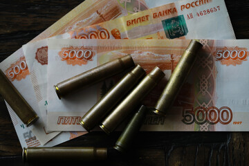 Wall Mural - Bullets lie on the russians money money with inscription five thousands rubles top view