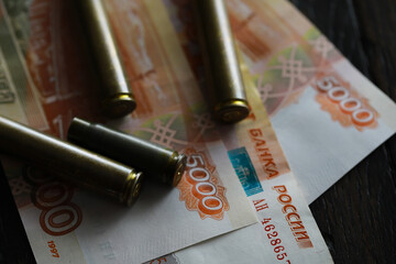 Wall Mural - Bullets lie on the russians money money with inscription five thousands rubles top view