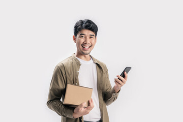 Wall Mural - Portrait handsome Asian man holding box and use smartphone on isolated white background.