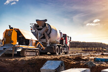 Concrete Mixer Truck Delivers Concrete To The Pump For Pouring Piles. Concrete Pump At The Construction Site. Close-up Of Concrete Delivery.