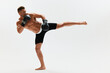 © SHOTPRIME STUDIO - Man athletic bodybuilder poses in boxing gloves with nude torso abs in full-length background, boxing and martial arts. Advertising, sports, active lifestyle, light, competition, challenge concept.