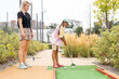 © Angelov - mother and daughter playing mini golf, children enjoying summer vacation