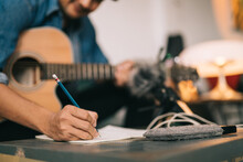 A Songwriter Or Composer, Close Up Of Songwriter Hands Composing Sheet Music Writing On Paper Professional Songwriter With Audio Recorder Digital Music Production.