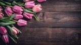 Fototapeta Kwiaty - Tulip border with copy space. Beautiful frame composition of spring flowers. Bouquet of pink tulips flowers on vintage wooden background
