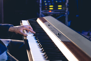 Wall Mural - A man plays the electronic piano, hands close-up.