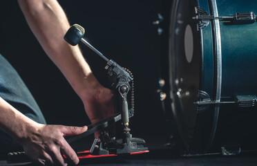 Wall Mural - Bass drum and drummer, musical instrument on black background.