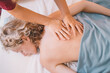 © Westend61 - Therapist giving back massage to woman in spa