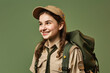 Prepared for Adventure: Happy scout with backpack isolated on army green background with space for text. Copy space. Scouting and Travel concept AI Generative