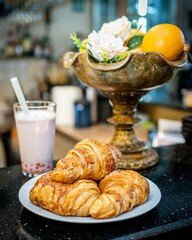 Sticker - Closeup of croissants with glass of juice on plate