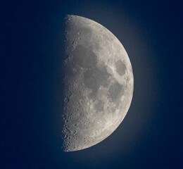 Sticker - Closeup of the white half moon in the night sky, cool for background