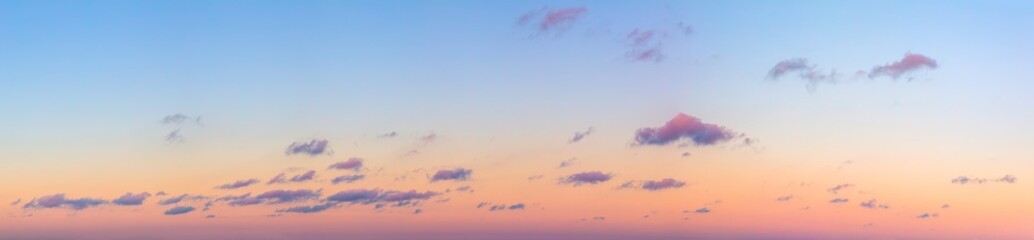 Wall Mural - ultra-wide panorama of the sunset sky. light separated colored clouds. there are no birds in the sky