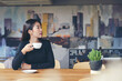 © prachid - Business woman drink coffee at office. Working woman sitting and relaxing Morning coffee break.