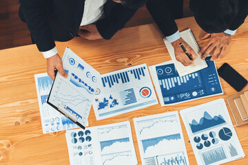 Poster - Top view analyst team discussing financial data on digital dashboard, analyzing chart and graph papers by data science software on wooden table background. Business intelligence and Fintech. Fervent