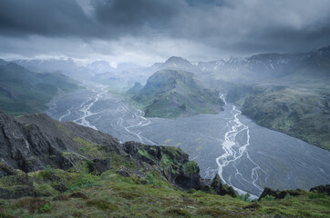 Wall Mural - Mysterious view of volcanic icelandic landscape from the top of Valahnukur hill in Thorsmork valley in the southern Iceland. Rainy, cloudy, misty day in Icelandic nature on late spring.