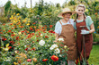 © Iryna - Closeup summer portrait of happy grandmother with grandchild teen girl outdoors. Senior woman pensioner with granddaughter working at garden.