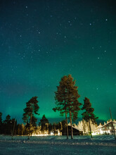 Northern Lights, Forest And Cabins In Levi Ski Resort, Kittilä, Lapland, Finland