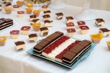 Poster - Close-up shot of an assortment of dessert pieces on a white table