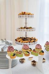 Poster - Vertical shot of an assortment of dessert pieces on a white table