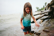 © Maria Manco/Stocksy - Girl frolics in water at beach