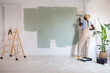 © Milles Studio/Stocksy - Black painter renovating light room at home