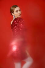 Fashionable Model On A Red Background With A Blur Effect