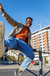 © Jovo Jovanovic/Stocksy - Excited man holding roadside fence and jumping in the air