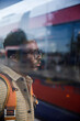 © Jovo Jovanovic/Stocksy - Serious man with backpack waiting for transport at tram station