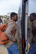 © Jovo Jovanovic/Stocksy - Man with backpack getting into tram at station