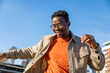 © Jovo Jovanovic/Stocksy - Cheerful man having fun outdoors in city